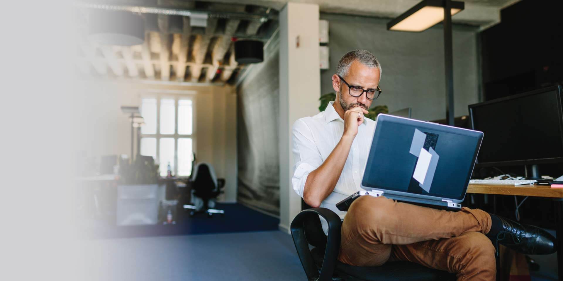 A small business owner working on his laptop